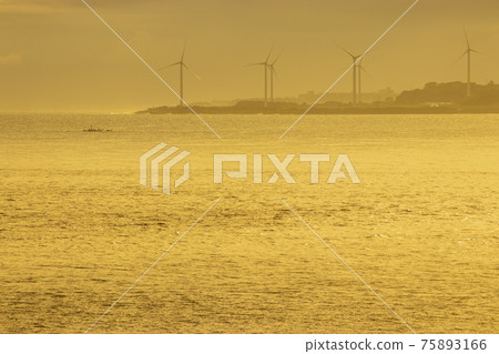 Sunrise over the Sea of Japan lined with windmills from the sandy beach of Sanin Kaike Onsen 75893166