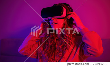 Young girl in virtual reality glasses at home Young girl in virtual reality glasses at home 75893209