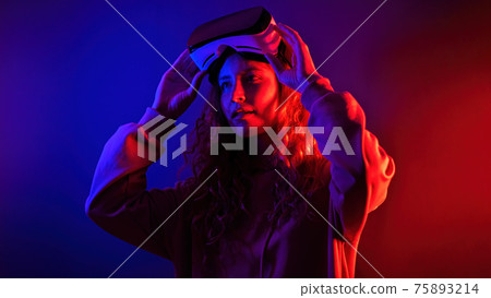 Young girl in virtual reality glasses at home 75893214