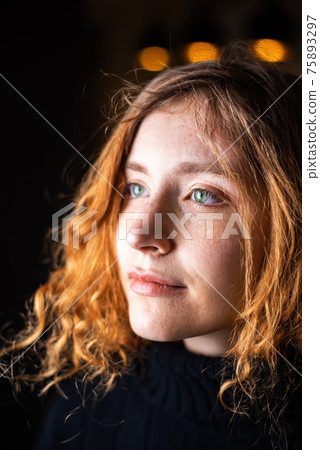 Portrait of young girl with ginger hair and green eyes 75893297