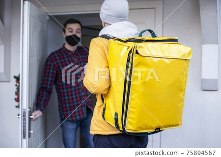 Delivery man with yellow backpack and client Delivery man with yellow backpack and client 75894567