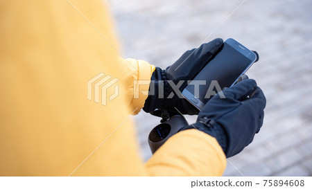 Food delivery man using smartphone Food delivery man using smartphone 75894608