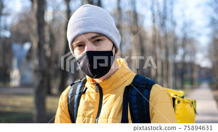 Food delivery man in a park 75894631