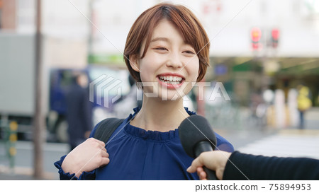 A woman undergoing a street interview A woman undergoing a street interview 75894953