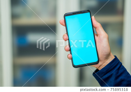 Green and blue screen for smartphone and chroma key compositing in men's hands Green and blue screen for smartphone and chroma key compositing in men's hands 75895318
