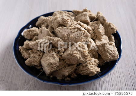 Halva or halvah on blue plate on the table. Halva or halvah on blue plate on the table. 75895573