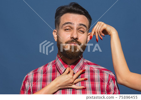 Half-length portrait of young Caucasian man isolated over blue background. 75896455