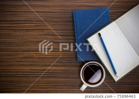 notebook with glasses and coffee on table 75896463