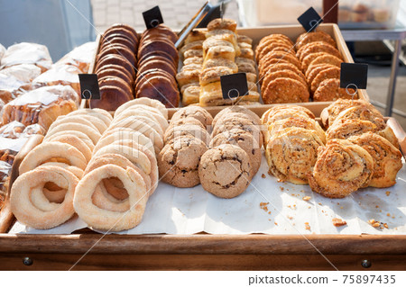Fresh baked cookies at a counter. Market bakery or cafe outdoors. Fresh baked cookies at a counter. Market bakery or cafe outdoors. 75897435