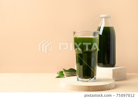 Chlorella Detox drink in glass on beige. Chlorella Detox drink in glass on beige. 75897812