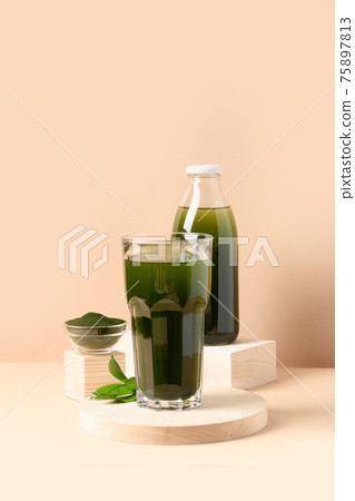 Chlorella Detox drink in glass on beige.  75897813