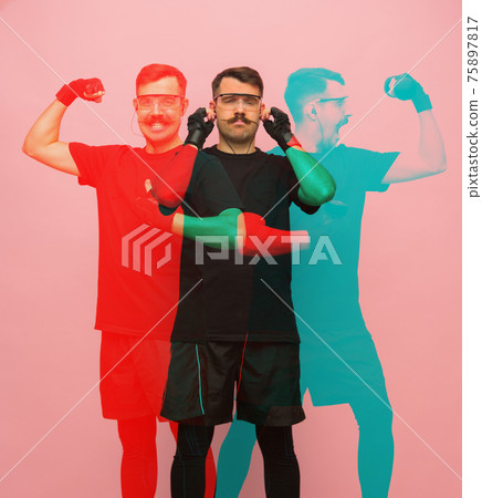 Young athletic man in black sports suit on pink background with glitch effect. Young athletic man in black sports suit on pink background with glitch effect. 75897817