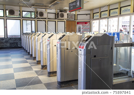 Modern metallic turnstile gate, entrance of railway station. Moscow, Russia 75897841