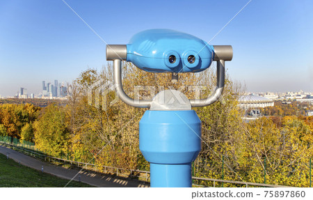 Touristic telescope viewer (binoculars) and view of central Moscow from Sparrow Hills or Vorobyovy Gory observation (viewing) platform-- is on a steep bank 85 m above the Moskva river, or 200 m above Touristic telescope viewer (binoculars) and view of central Moscow from Sparrow Hills or Vorobyovy Gory observation (viewing) platform-- is on a steep bank 85 m above the Moskva river, or 200 m above 75897860