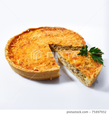 Homemade pie with champignons and cheese on a white background, side view. Sliced piece decorated with greens and nuts. Homemade pie with champignons and cheese on a white background, side view. Sliced piece decorated with greens and nuts. 75897932
