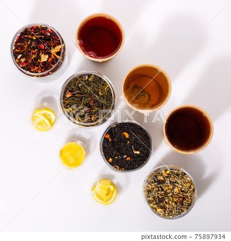 Many kinds of tea in paper cups on a white background. Top view. 75897934