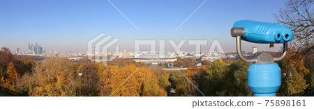 Touristic telescope viewer (binoculars) and Panoramic view of Sparrow Hills or Vorobyovy Gory observation (viewing) platform-- is on a steep bank 85 m above the Moskva river, or 200 m above sea level. 75898161