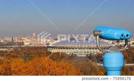 Touristic telescope viewer (binoculars) and Panoramic view of Sparrow Hills or Vorobyovy Gory observation (viewing) platform-- is on a steep bank 85 m above the Moskva river, or 200 m above sea level. 75898170