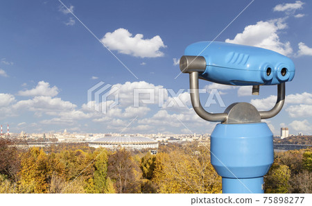 Touristic telescope viewer (binoculars) and view of central Moscow from Sparrow Hills or Vorobyovy Gory observation (viewing) platform-- is on a steep bank 85 m above the Moskva river, or 200 m above Touristic telescope viewer (binoculars) and view of central Moscow from Sparrow Hills or Vorobyovy Gory observation (viewing) platform-- is on a steep bank 85 m above the Moskva river, or 200 m above 75898277