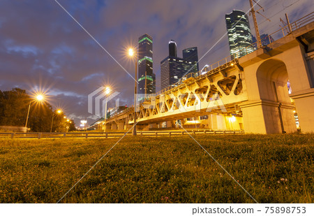 Moscow Central Circle (Little Ring, MCC,or MK MZD) and skyscrapers of the International Business Center (City) at night, Russia. Delovoy Tsentr railway station Moscow Central Circle (Little Ring, MCC,or MK MZD) and skyscrapers of the International Business Center (City) at night, Russia. Delovoy Tsentr railway station 75898753