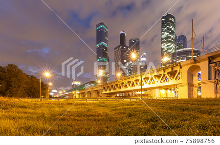 Moscow Central Circle (Little Ring, MCC,or MK MZD) and skyscrapers of the International Business Center (City) at night, Russia. Delovoy Tsentr  railway station 75898756