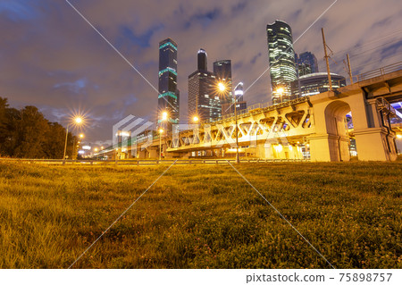 Moscow Central Circle (Little Ring, MCC,or MK MZD) and skyscrapers of the International Business Center (City) at night, Russia. Delovoy Tsentr railway station Moscow Central Circle (Little Ring, MCC,or MK MZD) and skyscrapers of the International Business Center (City) at night, Russia. Delovoy Tsentr railway station 75898757