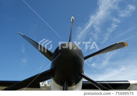 Small plane propeller closeup against blue sky Small plane propeller closeup against blue sky 75899575