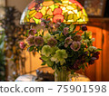 Interior decoration with Christmas rose flower arrangement and stained glass desk lamp 75901598