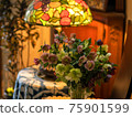 Interior decoration with a bouquet of Christmas roses and a stained glass desk lamp 75901599