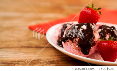 Homemade strawberry ice cream on white plate on a rustic background. 75901980