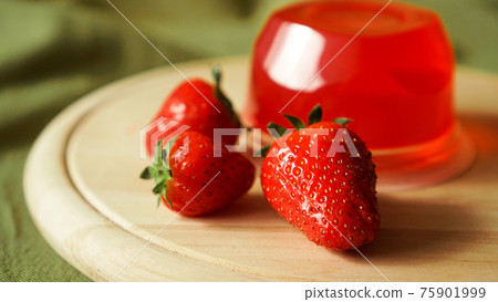 Red strawberry jelly with berries in a plastic container 75901999