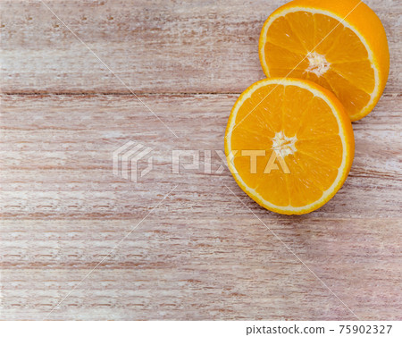Orange halves on a wooden background. Orange halves on a wooden background. 75902327