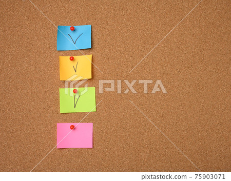 colorful paper stickers glued to brown cork board colorful paper stickers glued to brown cork board 75903071