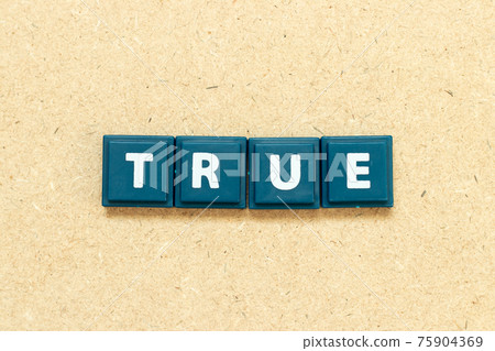 Tile alphabet letter in word true on wood background 75904369