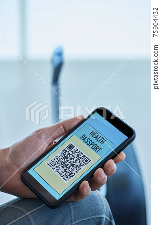 man has an electronic health passport in his phone man has an electronic health passport in his phone 75904432