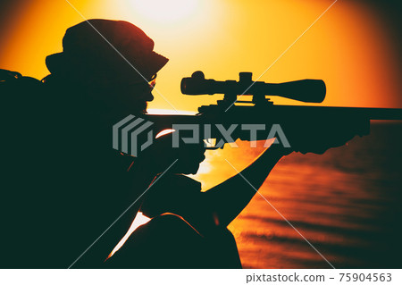 Commando sniper aiming, shooting rifle on seacoast Commando sniper aiming, shooting rifle on seacoast 75904563