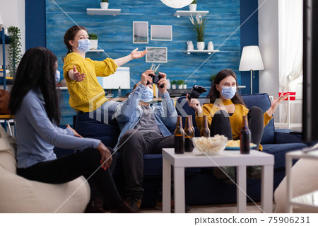 Happy cheerful woman screaming after wining gaming competiton 75906231