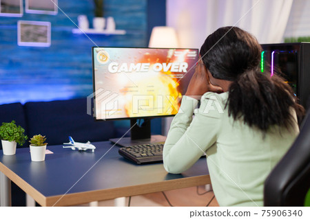 Disappointed sad african woman after losing online game competition 75906340
