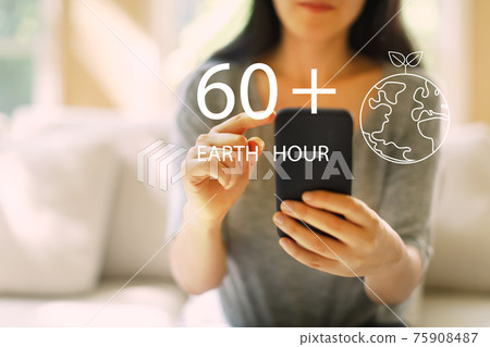 Earth hour with woman using a smartphone Earth hour with woman using a smartphone 75908487