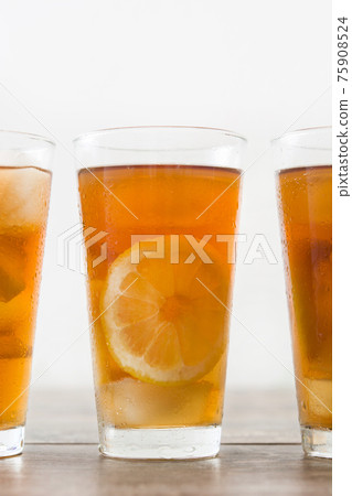 Fresh ice tea on wooden table Fresh ice tea on wooden table 75908524