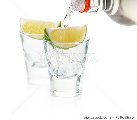 strong alcohol pouring into shot glasses strong alcohol pouring into shot glasses 75908680