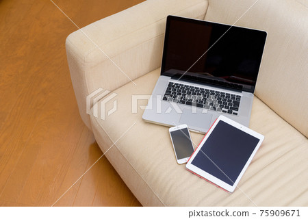 Computer, smartphone and tablet on the sofa Computer, smartphone and tablet on the sofa 75909671