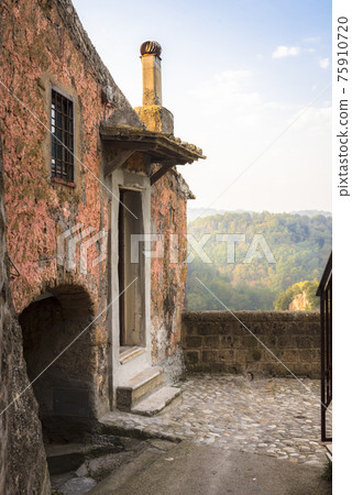 View of the mountain valley from the abandoned house in medieval commune town of Calcata, Italy 75910720