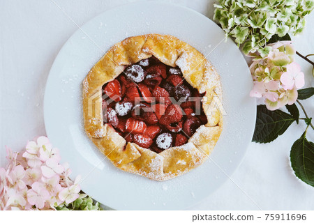 Delicious freshly baked vegan strawberry and cherry galette. Delicious freshly baked vegan strawberry and cherry galette. 75911696