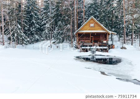russian sauna banya house in winter forest nearby the lake with ice-hole 75911734