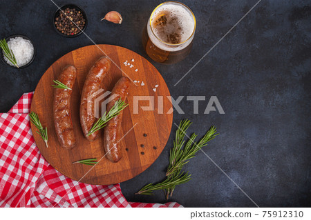 Raw meat beef sausages for grill and spicy, herbs rosemary, pepper, salt on table Raw meat beef sausages for grill and spicy, herbs rosemary, pepper, salt on table 75912310