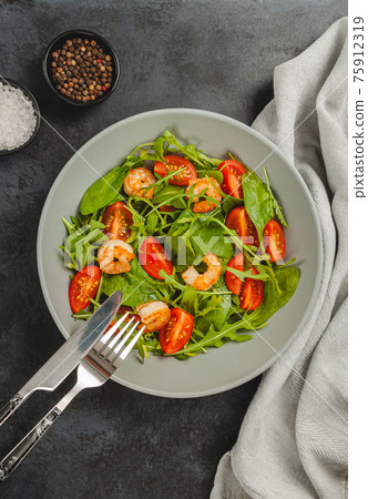 Salad of shrimp prawn and fresh vegetable, leaves of arugula, lettuce. Salad of shrimp prawn and fresh vegetable, leaves of arugula, lettuce. 75912319