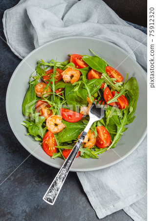 Salad of shrimp prawn and fresh vegetable, leaves of arugula, lettuce. Salad of shrimp prawn and fresh vegetable, leaves of arugula, lettuce. 75912320