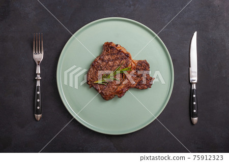 T-bone grilled beef steak with spices and herbs T-bone grilled beef steak with spices and herbs 75912323