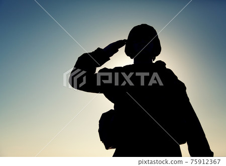 Silhouette of soldier salutes on sunset background Silhouette of soldier salutes on sunset background 75912367